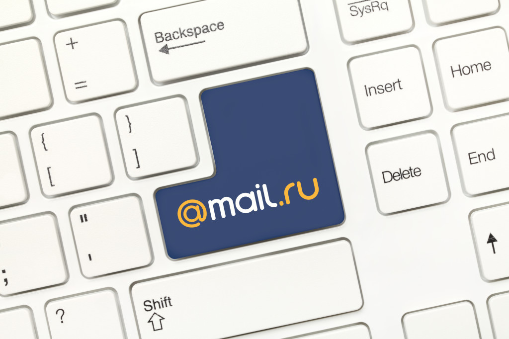 Close-up view on white conceptual keyboard - Mail.ru (key with logotype)
