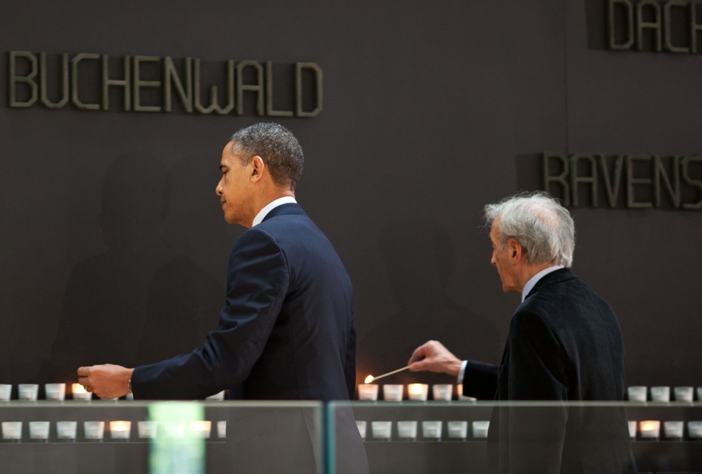 President Barack Obama, with Elie Wiesel, Nobel Peace Prize laureate and Holocaust survivor, lights a candle at the Buchenwald Memorial during a tour of the United States Holocaust Memorial Museum in Washington, D.C., April 23, 2012. (Official White House Photo by Pete Souza)