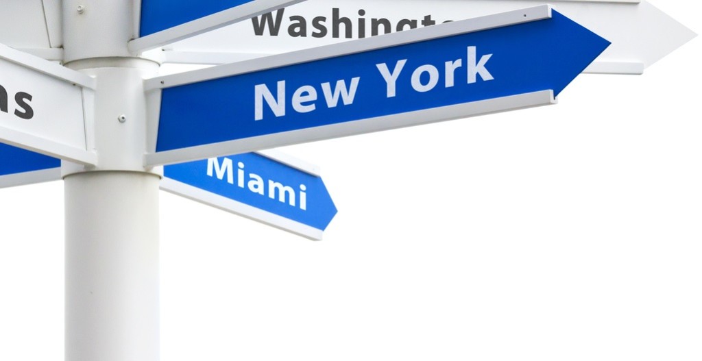 Major US cities on a crossroads directional sign.
