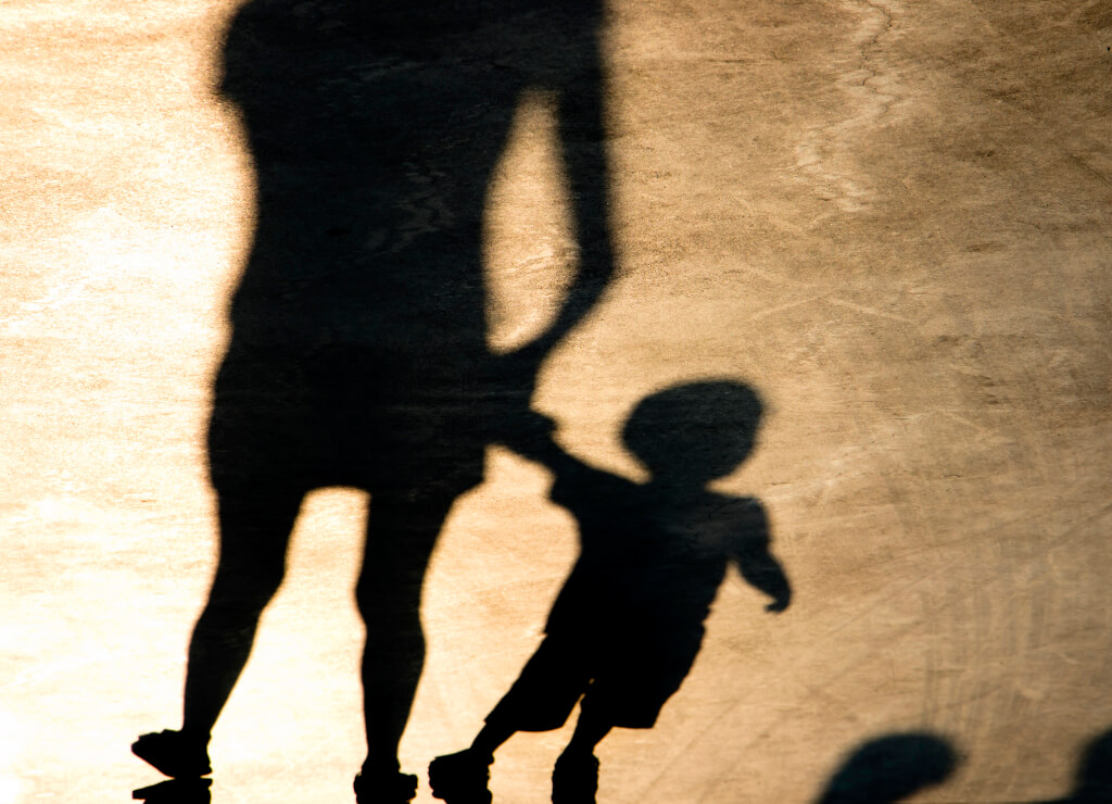 Shadows silhouettes of mother and son walking