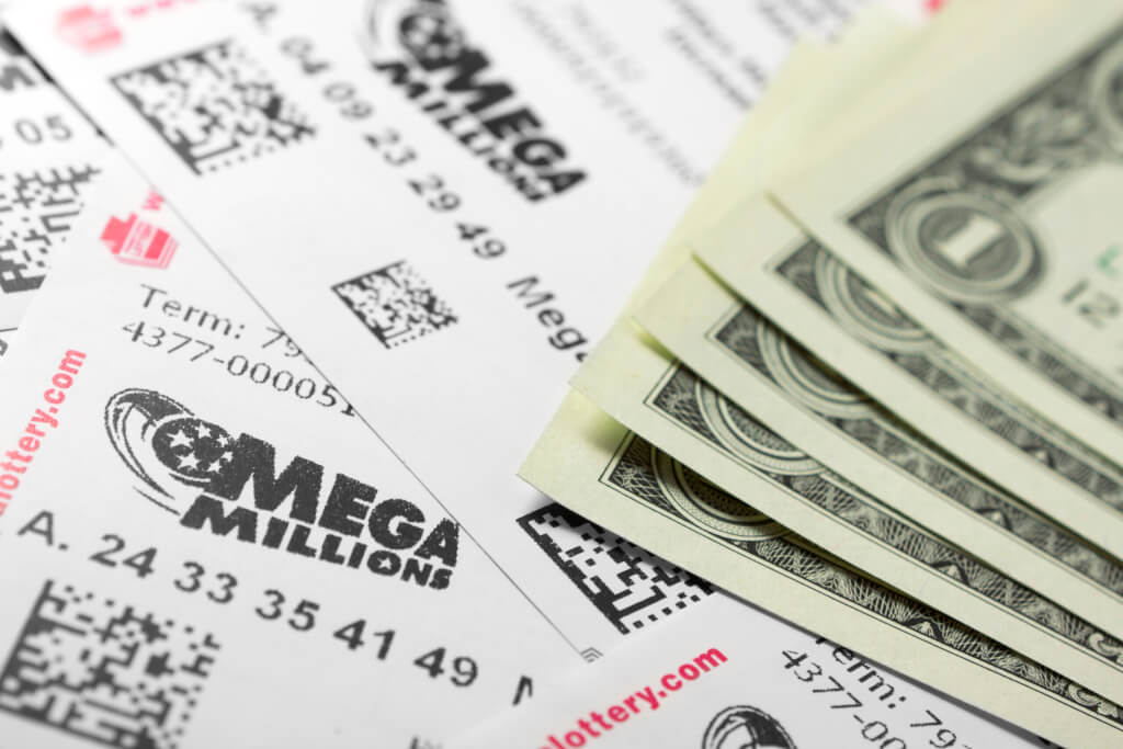 Mega Millions lottery tickets and one dollar bills