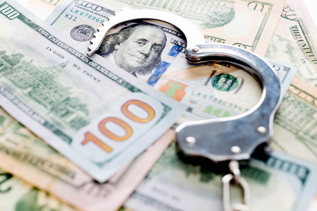 Handcuffs lying on american dollars
