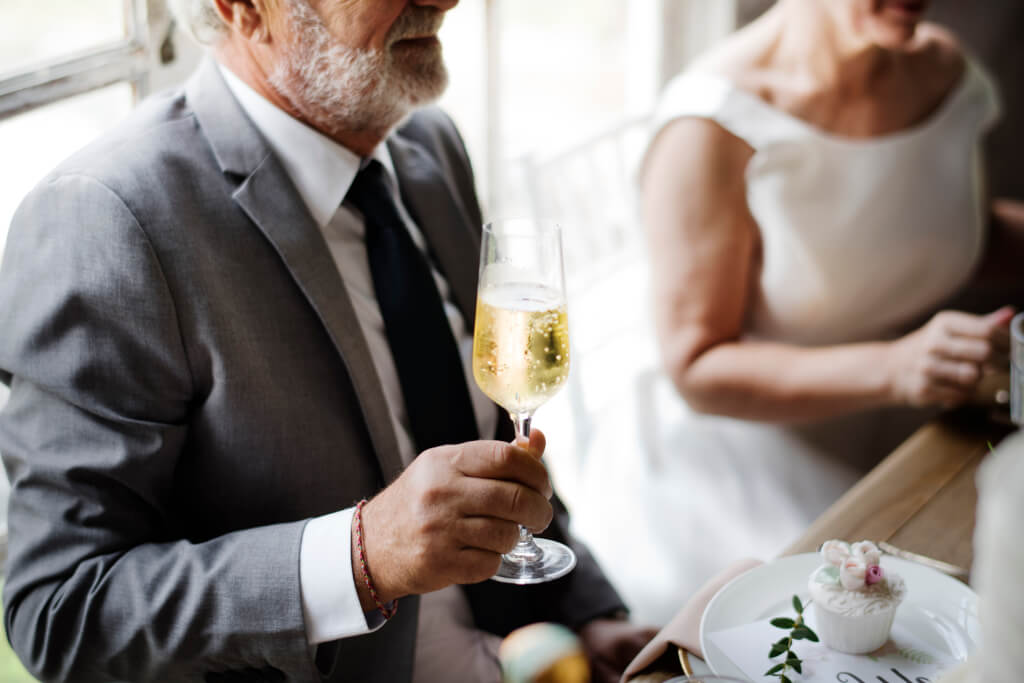 Groom hand holding champagne glass