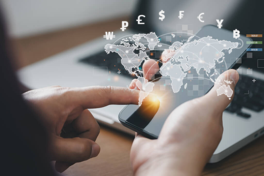 Man using mobile phone and laptop computer to money transfers