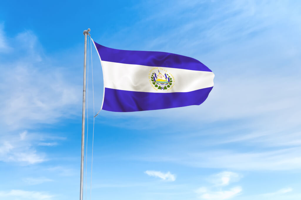 El Salvador flag blowing in the wind over nice blue sky background