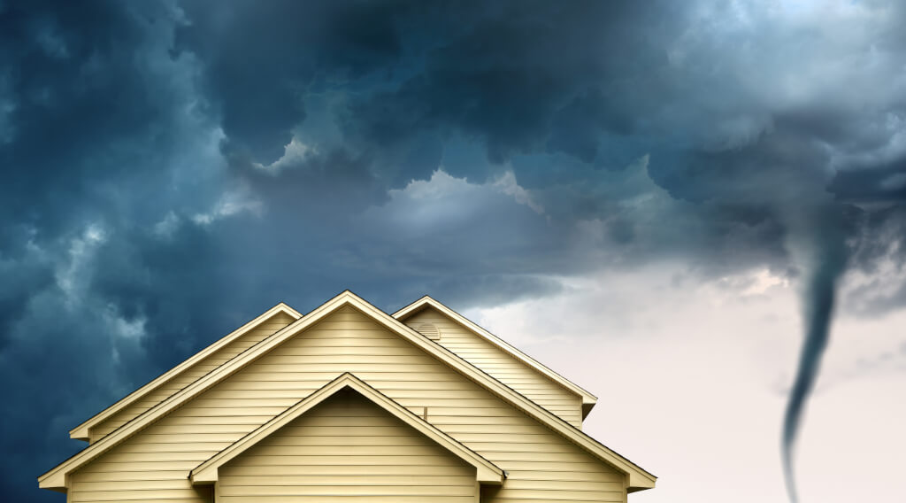 close up rooftop of wooden house over stormy clouds sky and approaching tornado