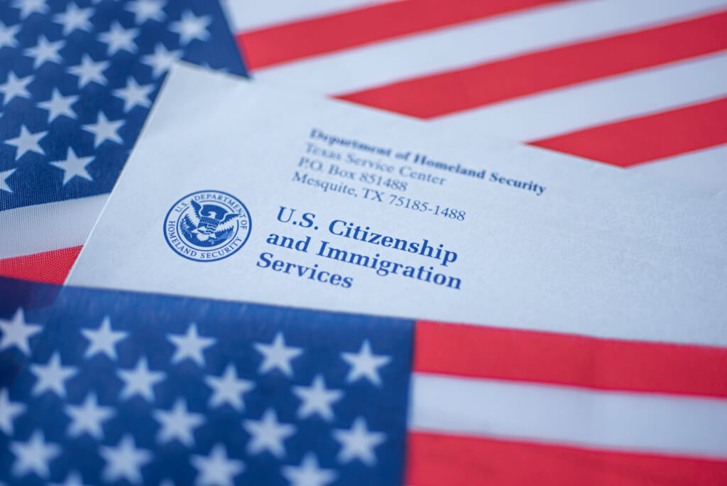 Letter (Envelope) from USCIS covered in flag of USA on American colors background
