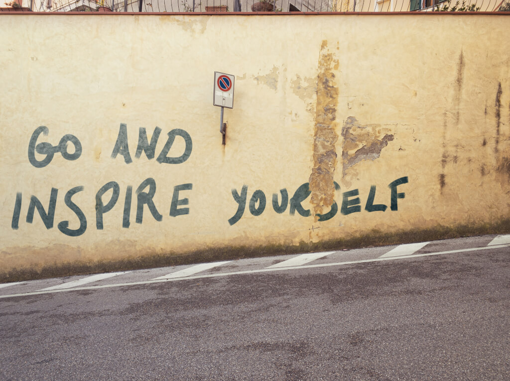 Graffiti: "go and inspire yourself" on a wall.