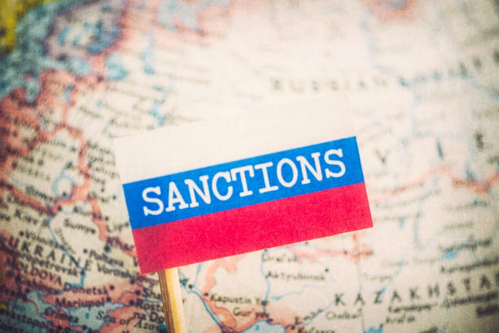 word Sanctions on Russia flag