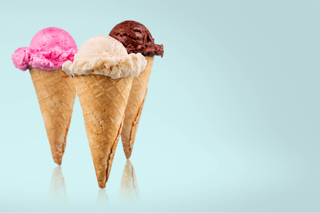 Ice cream scoops with vanilla, chocolate and berry scoops and topping